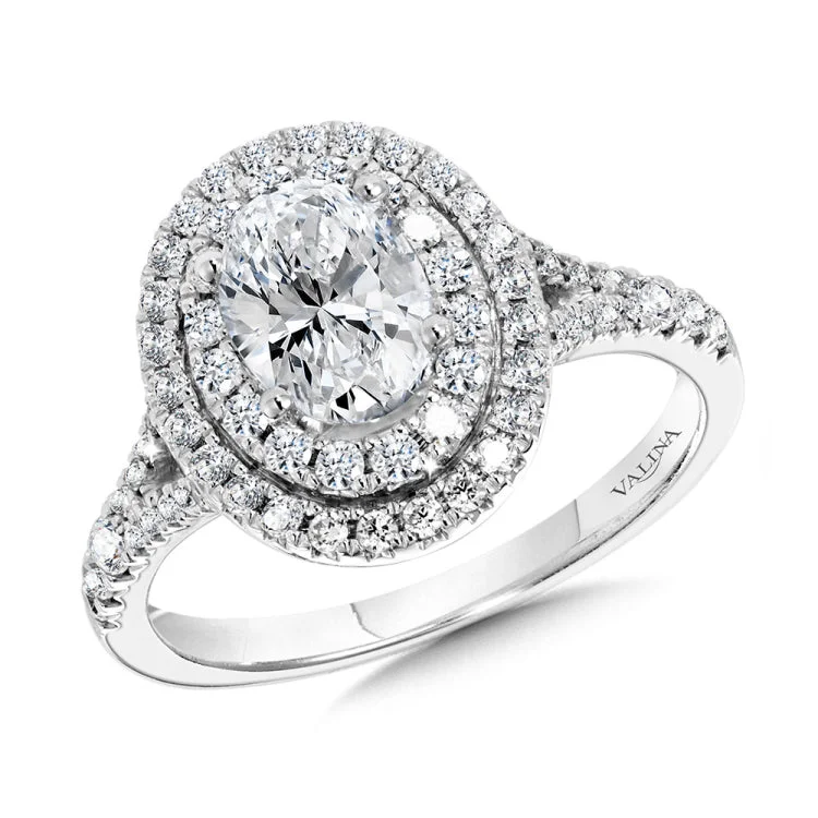 The round shank splits just below the large oval-shaped double-halo head, creating a bold statement engagement ring design.