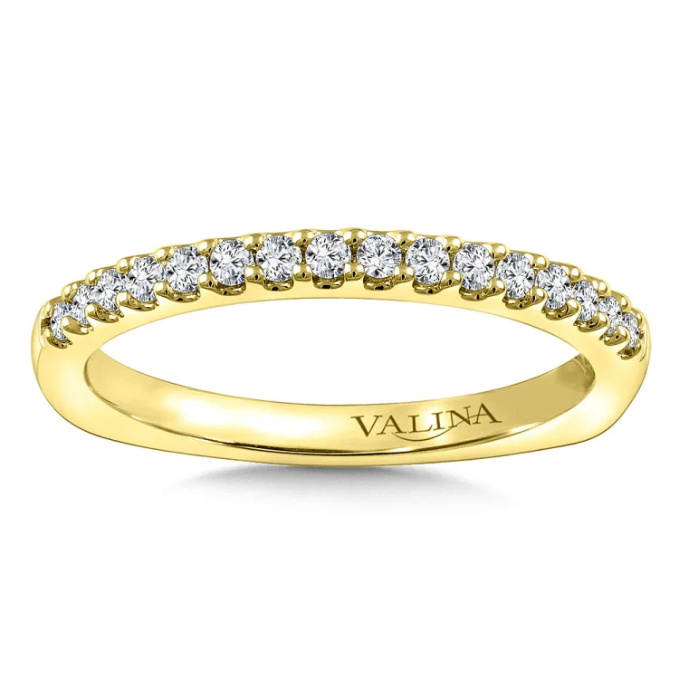 Diamond stackable wedding band in 14k yellow gold.