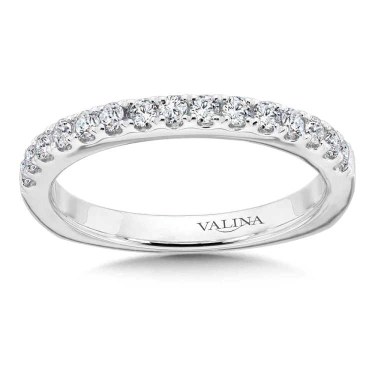 Wedding band with a delicate band of diamonds set in 14k white gold.